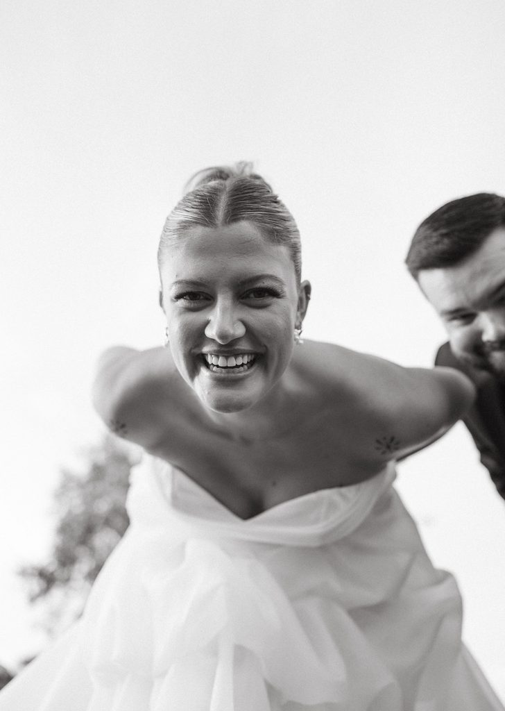 Close-up black and white portrait of bride smiling with groom during reception at The Bower in Edmond, Oklahoma.