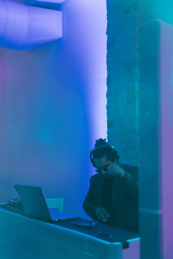 Wedding DJ from All Out DJ performing under blue and purple lighting setup during reception dance floor party at The Bower.