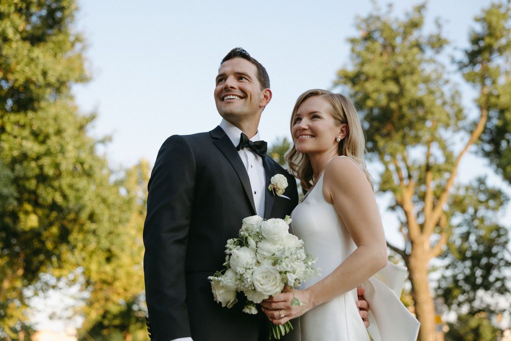 Bride and groom standing outdoors during wedding portraits at Gaylord-Pickens Museum in Oklahoma City.