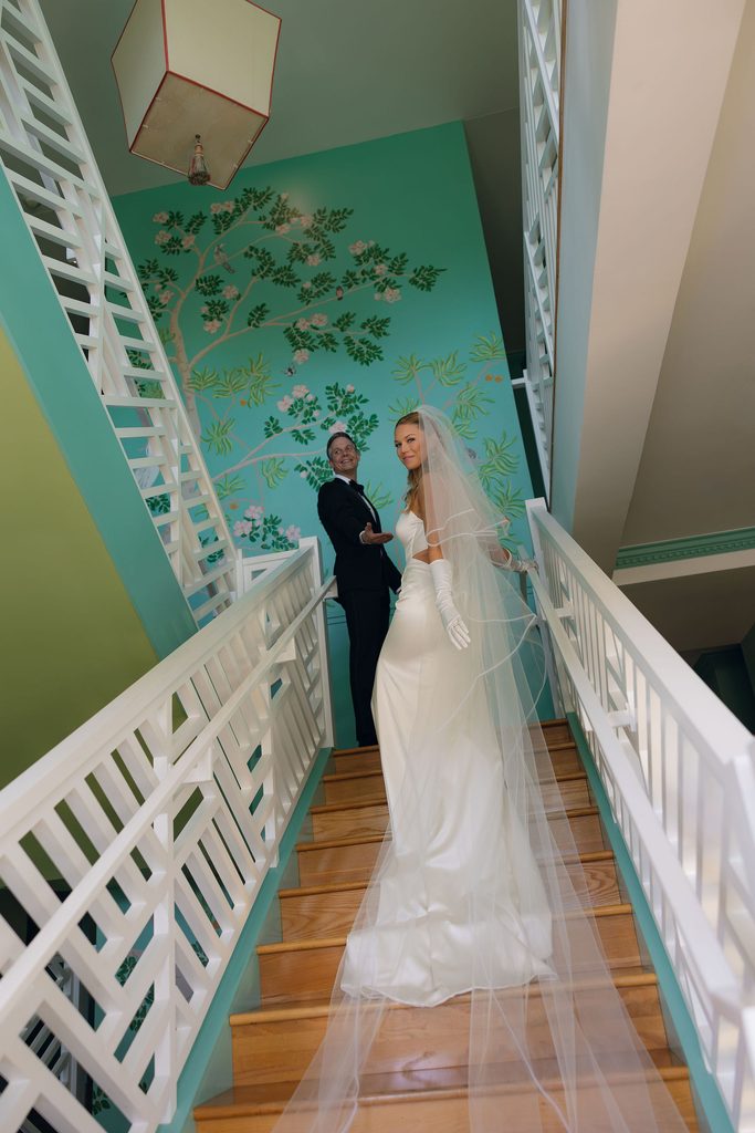 Bride and groom walking up staircase after ceremony